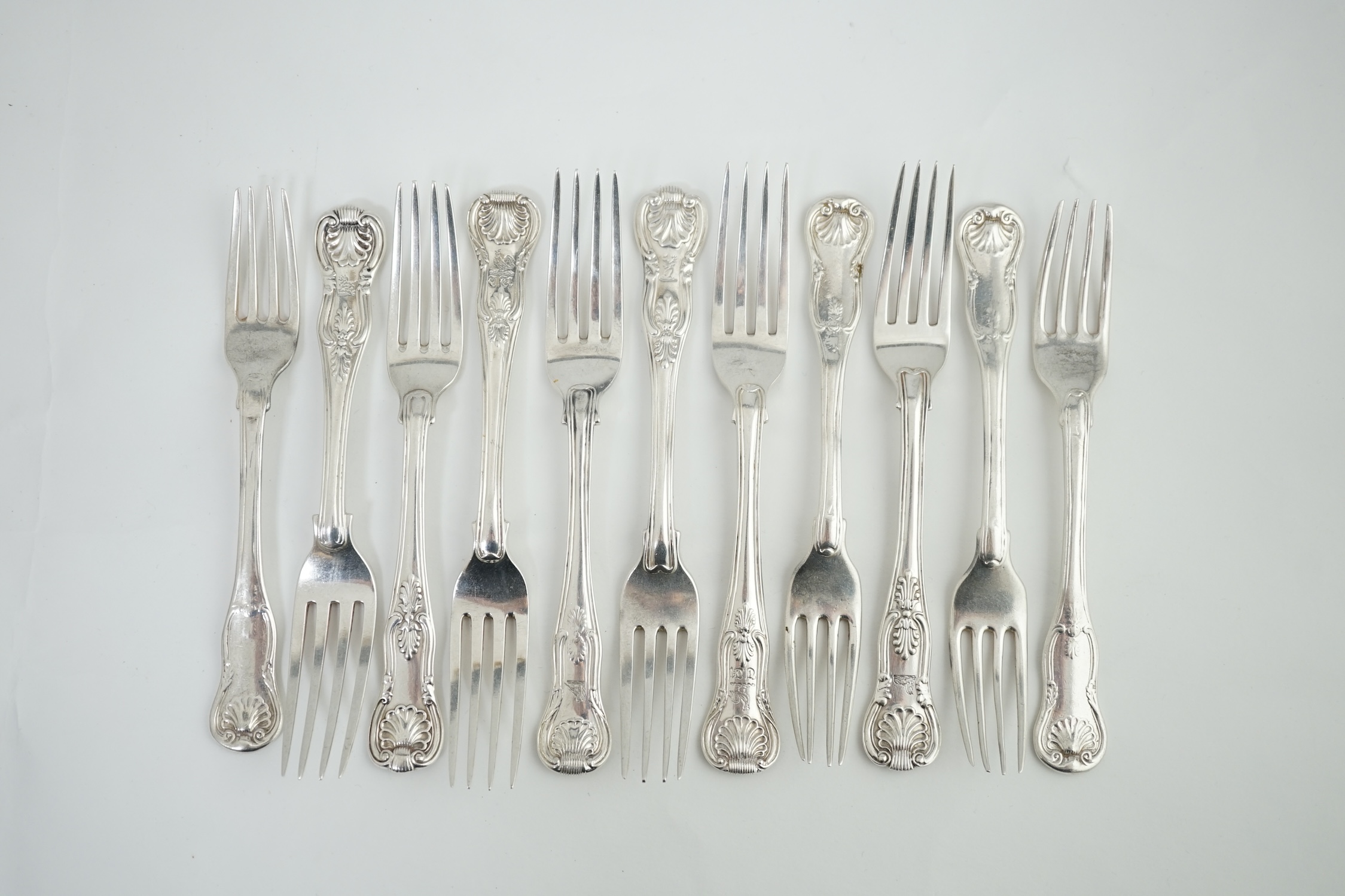 A harlequin set of eleven Georgian and Victorian silver Kings pattern dessert forks, various dates and makers